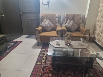 Seven seater sofa in skin colour with dark brown flowers on it