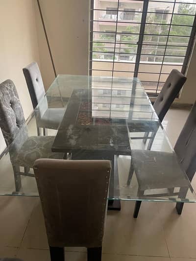 8 seater glass top dinning table for sale only 5 chairs available