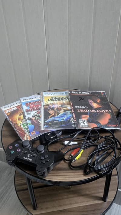 PS2 with 5 cds and 1 wireless controller
