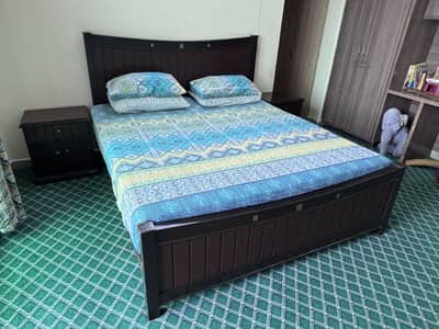 Wooden double bed with side tables