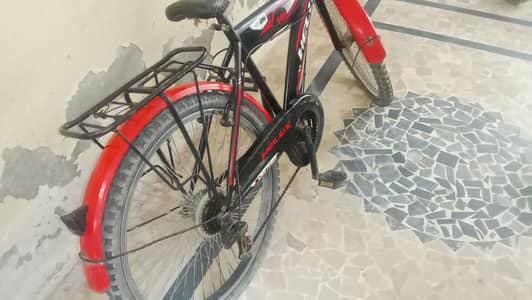 Red and black color bicycle with gears