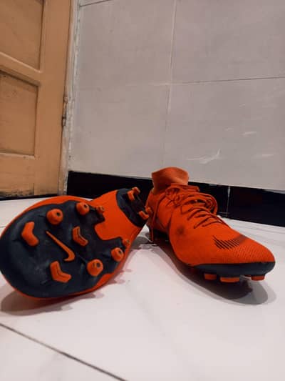 Orange Nike Mercurial football shoes