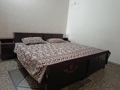 2 wooden single beds with side drawers and mattresses