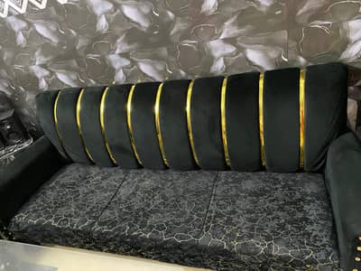 black and golden sofa set with table