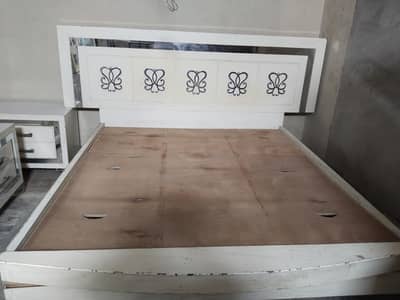 bed with side tables and dressing table