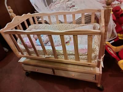 wooden baby cot with storage drawers and wheels