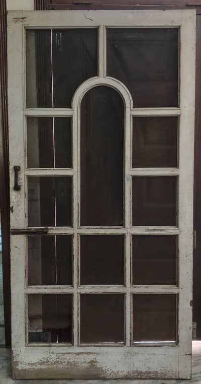 strong wodden door with metal handle and bolt
