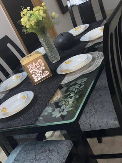 6 seater dining table . with glass top. Turkish fabric cushion