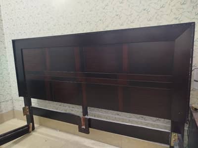 Dark brown king size bed with side tables