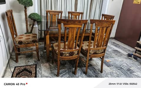 Wood dining table with heavy glass