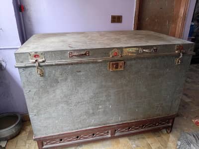 large iron storage trunk with wooden stand