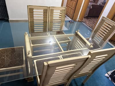Wooden dining table with glass top and with 6 chairs