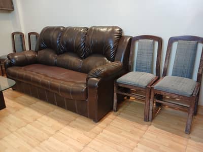 7 seater sofa with its 6 seat and table and 4 wooden chairs