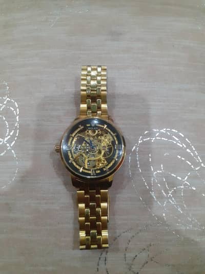 Gold Toned Automatic Watch With A Black Dial