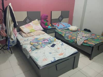 twin bed with mattress and side table