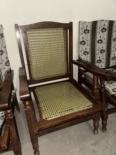 6 used wooden arm chairs with cane and cushions