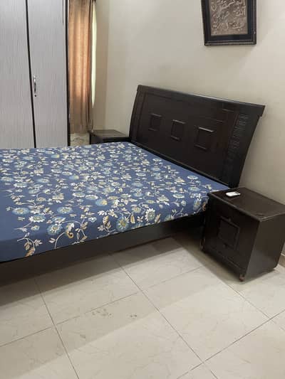 Wooden bed with mattress in used condition with side tables dressing