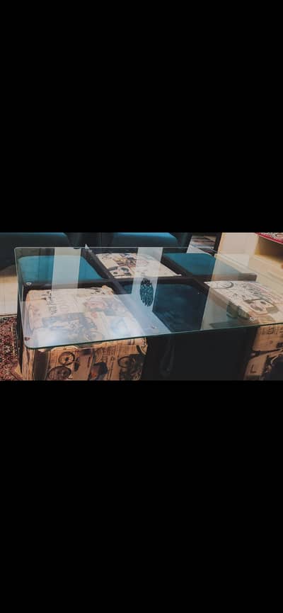 Glass top center table + 6 Ottoman Stools