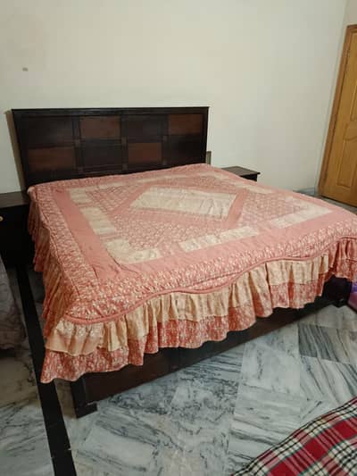 Wooden bed with mattress