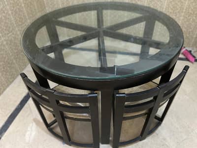 Elegant round black glass top dining table with matching chairs