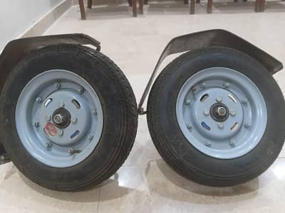 two supporting tyres of electric Scooty along with rims and  accessori
