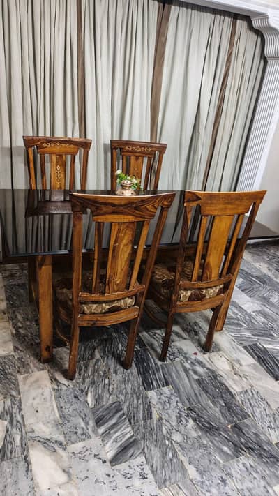 Wood dining table with heavy glass