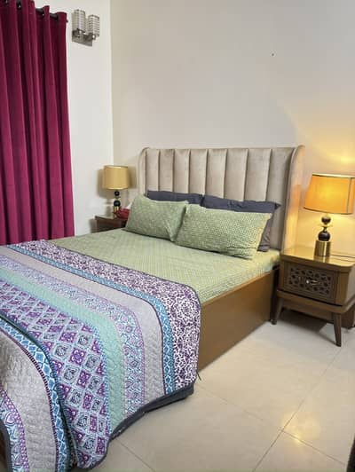 Queen bed with side tables, mattress and dressing.