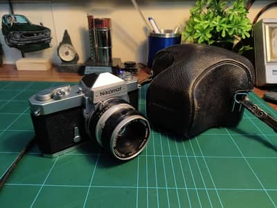 Vintage Nikon SLR camera with 50mm lens and carry case