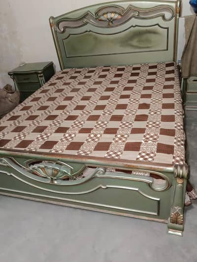 king size bed with 2 side tables and a dressing table