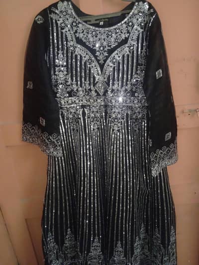 black flared maxi and heavy silver embroidery