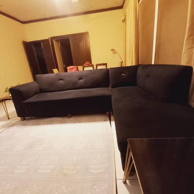 L shape sofa black valved with center piece and side tables