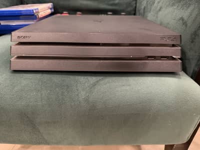 ps4 pro 1tb with 4 cds and 2 stock controllers