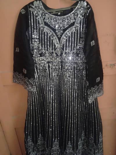 black flared maxi and heavy silver embroidery