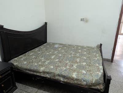 Wooden bed and mattress