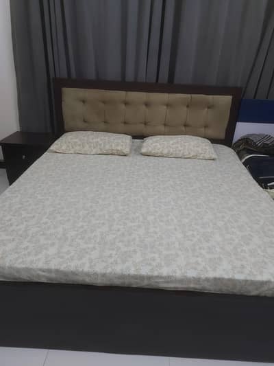 king size wooden bed and dressing table