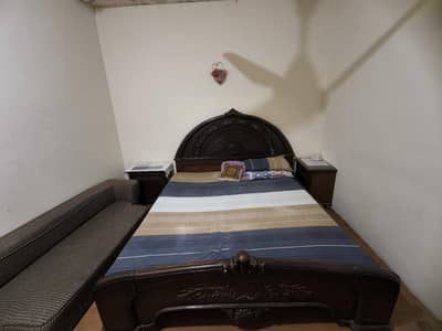 one bed and two side tables