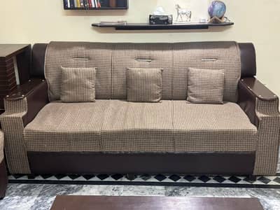 9 seater sofa set with a set of three tables .