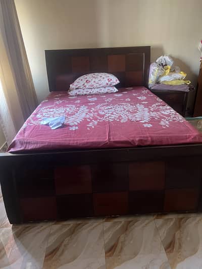 Bed with mattress and one side table