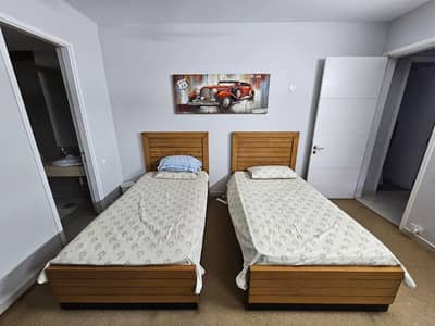2 single bed and one side table