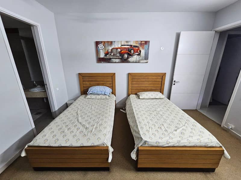 2 single bed and one side table 0
