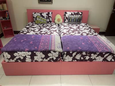Singles beds with side tables and a castle shelf