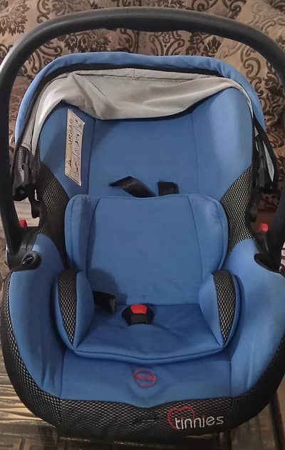 tinnies carry cot/car seat for sale
