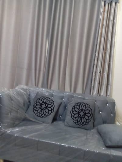 L shape sofa. 2 puffy  1 table  4 curtains 1 center piece