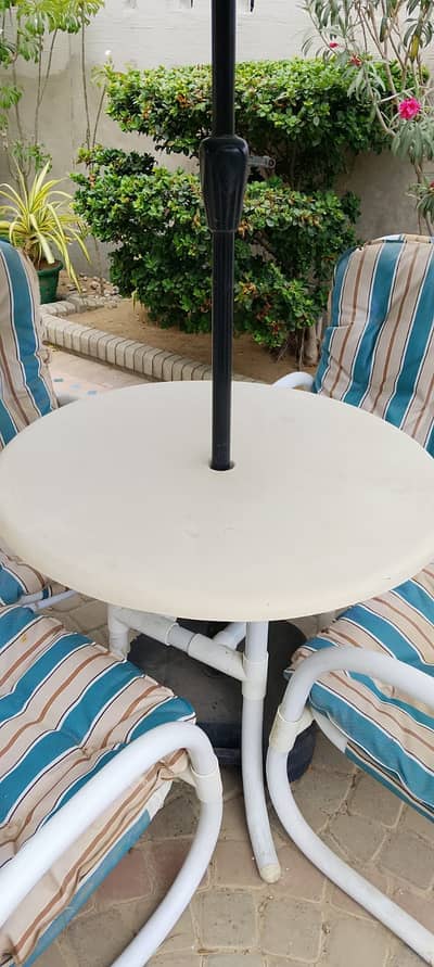 Outdoor furniture, 4 chairs, table and large umbrella.
