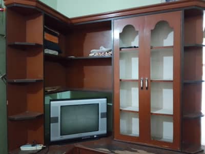 Large wooden TV console with book shelf.