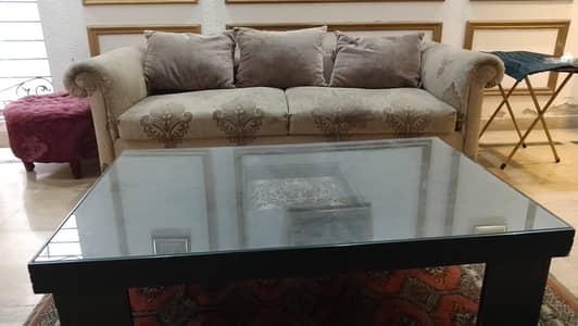 Used sofa set along with center table and puffy stool for sale.
