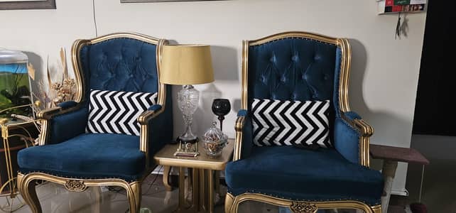 two wing chairs with cushions