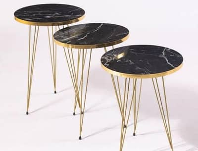 round coffee tables set of 3 in color white and black .