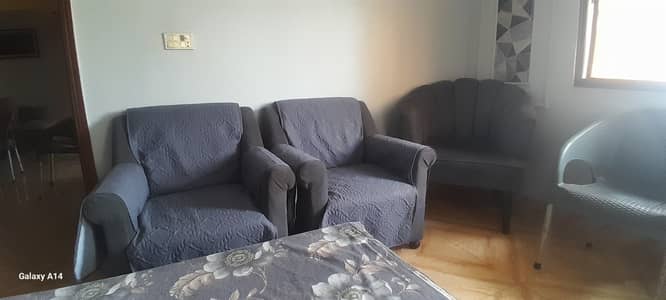 Grey coloured sofa with covers 9/10 condition