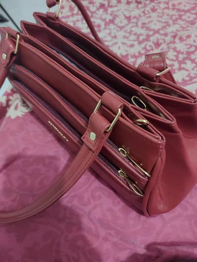 7 zippers Elegant maroon handbag